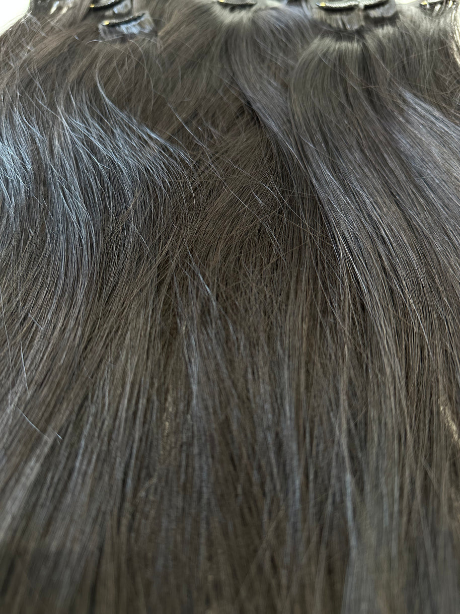Close-up of gray hair extensions with clips.