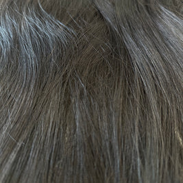 Close-up of gray hair extensions with clips.