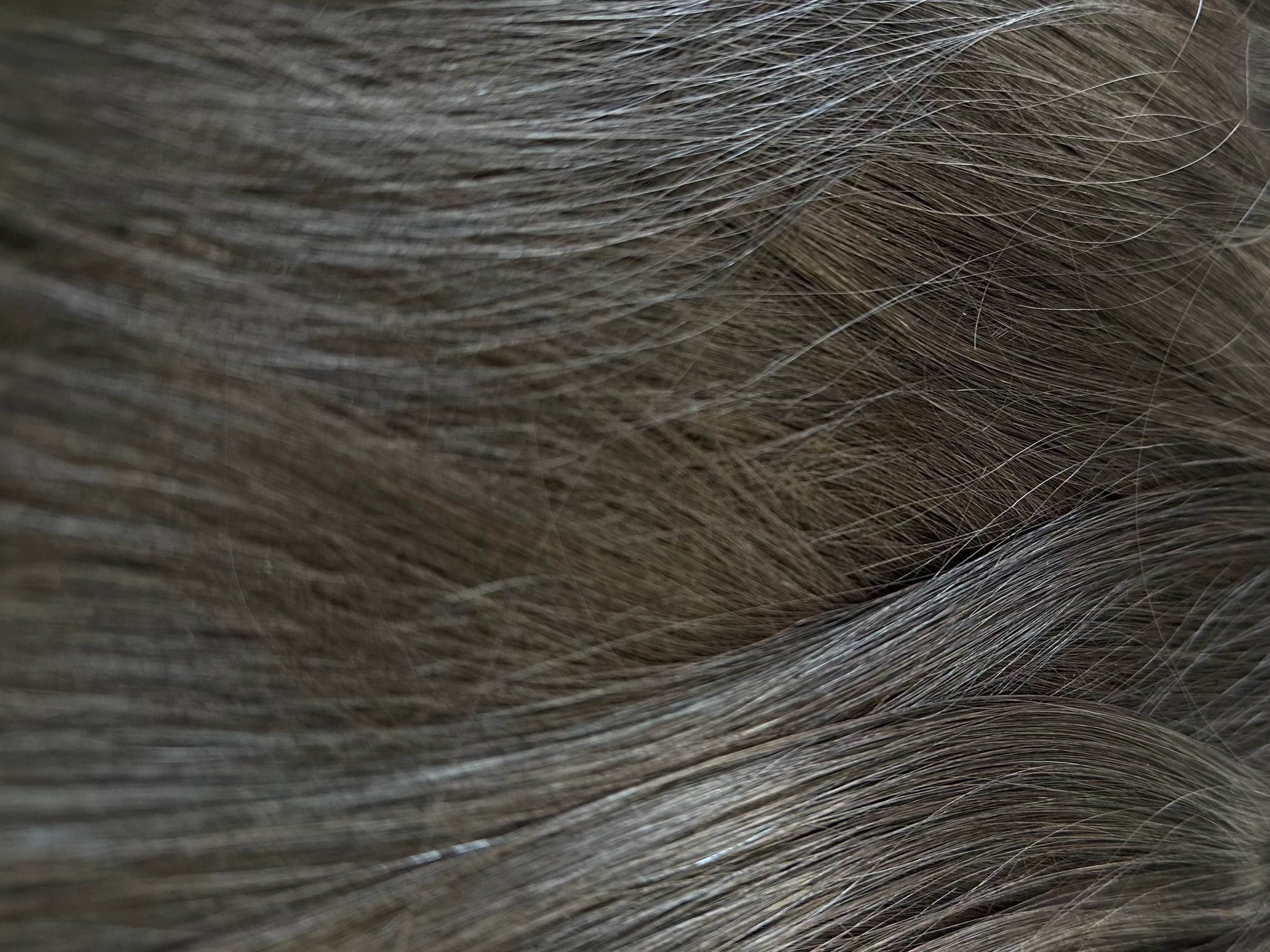 Close-up of black hair extensions with clips on a white background