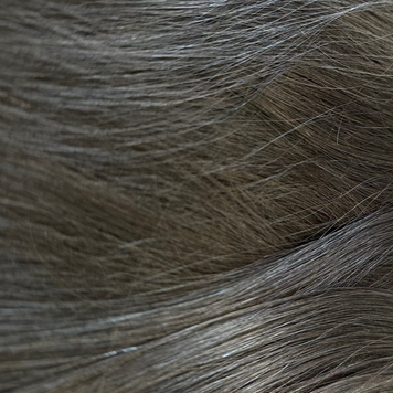 Close-up of black hair extensions with clips on a white background