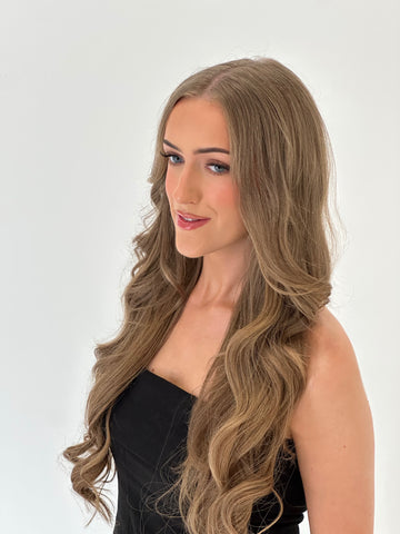 Woman with long, wavy hair on a white background